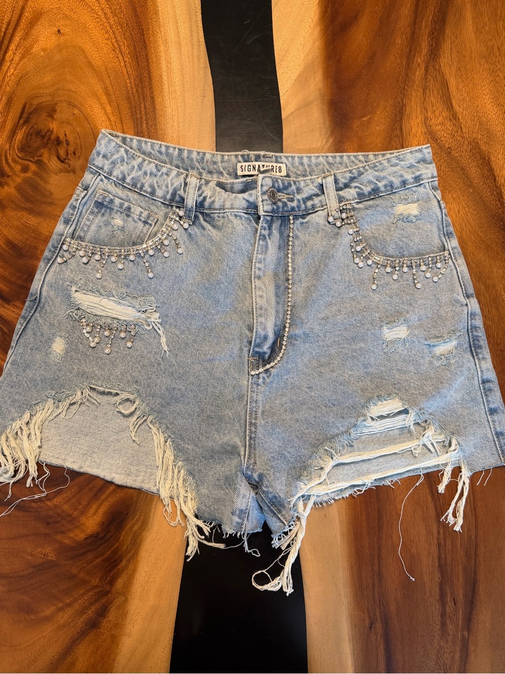 Dressed in LALA rhinestone denim shorts